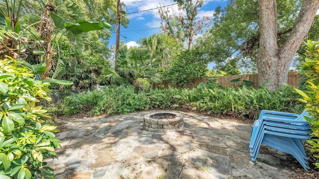 4219 Forest Hills Dr, Lakeland, FL 33813 - fenced backyard featuring a fire pit and a patio