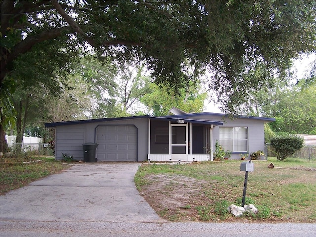 1120 Ivy Ln, Bartow, FL 33830 - single story home with a sunroom, an attached garage, and concrete driveway