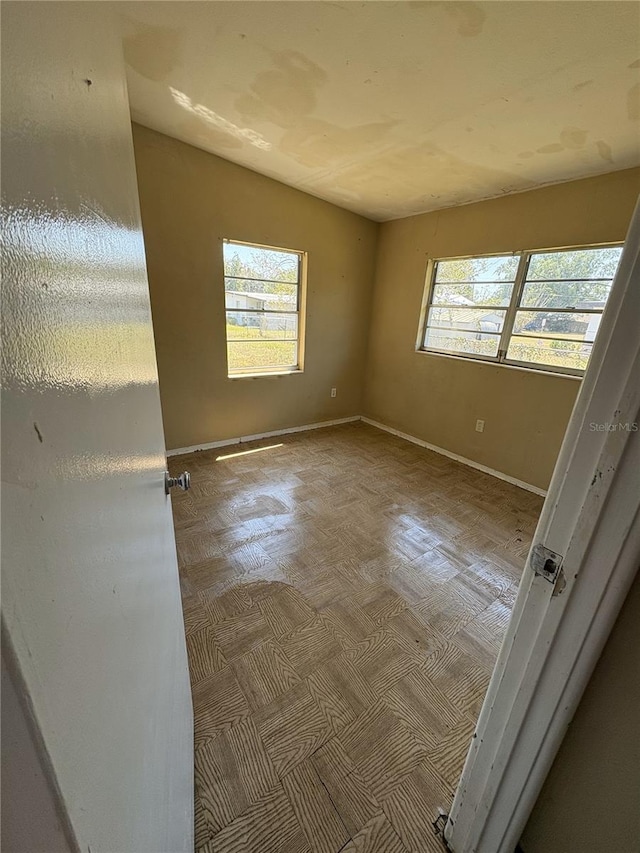 1120 Ivy Ln, Bartow, FL 33830 - empty room with healthy amount of natural light and baseboards