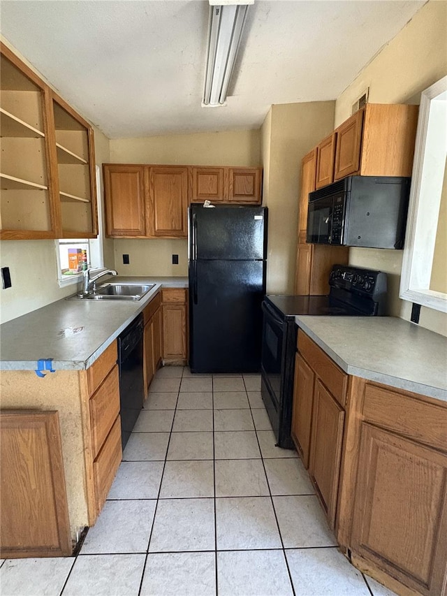 1120 Ivy Ln, Bartow, FL 33830 - kitchen with black appliances, brown cabinets, light tile patterned floors, a sink, and light countertops