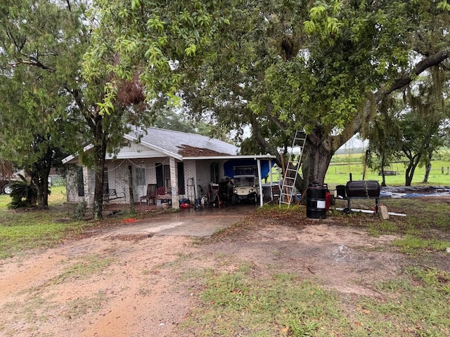 4011 E Robinson Dr, Haines City, FL 33844 - view of front facade featuring driveway, a porch, and an attached carport