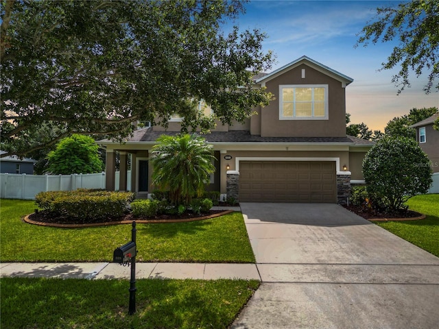 228 Magneta Loop, Auburndale, FL 33823 - view of front of home featuring stucco siding, a garage, concrete driveway, and stone siding
