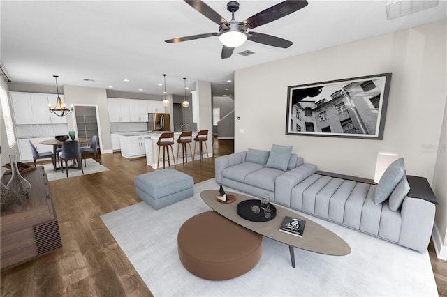 228 Magneta Loop, Auburndale, FL 33823 - living area with dark wood-style flooring, a chandelier, a ceiling fan, and recessed lighting