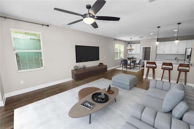 228 Magneta Loop, Auburndale, FL 33823 - living area featuring wood finished floors, recessed lighting, a chandelier, and a ceiling fan