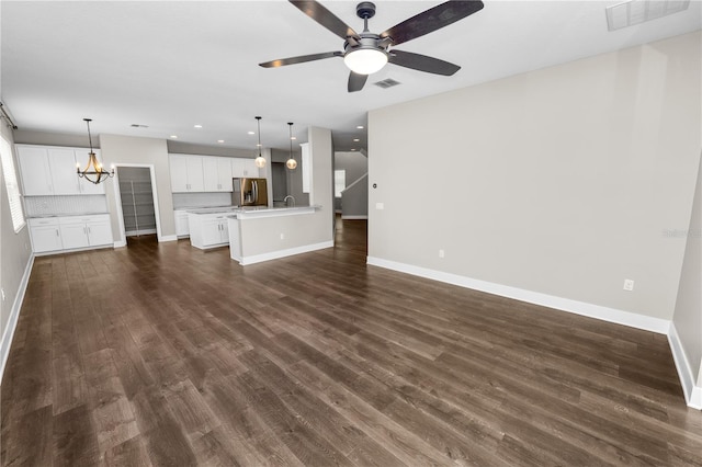 228 Magneta Loop, Auburndale, FL 33823 - unfurnished living room featuring a ceiling fan, dark wood finished floors, a chandelier, and recessed lighting