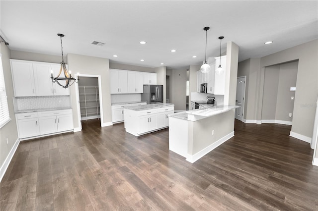 228 Magneta Loop, Auburndale, FL 33823 - kitchen with stainless steel appliances, backsplash, recessed lighting, a peninsula, and a chandelier