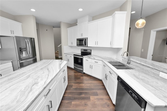 228 Magneta Loop, Auburndale, FL 33823 - kitchen featuring stainless steel appliances, white cabinetry, dark wood-type flooring, recessed lighting, and decorative backsplash