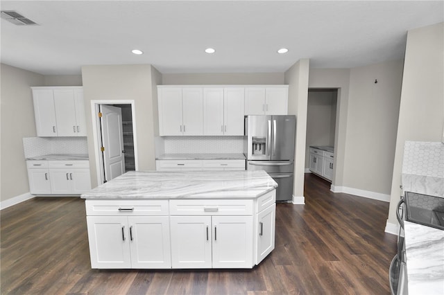 228 Magneta Loop, Auburndale, FL 33823 - kitchen with stainless steel fridge, electric range oven, decorative backsplash, dark wood-type flooring, and white cabinets