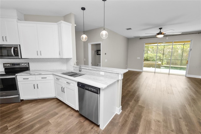 228 Magneta Loop, Auburndale, FL 33823 - kitchen featuring stainless steel appliances, ceiling fan, wood finished floors, and white cabinetry