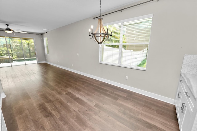 228 Magneta Loop, Auburndale, FL 33823 - unfurnished dining area featuring a chandelier, a ceiling fan, and dark wood-style floors