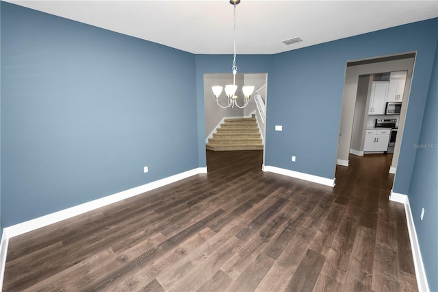 228 Magneta Loop, Auburndale, FL 33823 - unfurnished dining area featuring a chandelier, stairway, and dark wood finished floors