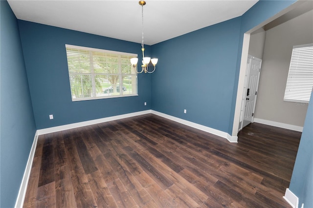 228 Magneta Loop, Auburndale, FL 33823 - unfurnished room with a chandelier and dark wood-style floors