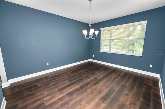 228 Magneta Loop, Auburndale, FL 33823 - unfurnished room featuring a chandelier and dark wood-type flooring