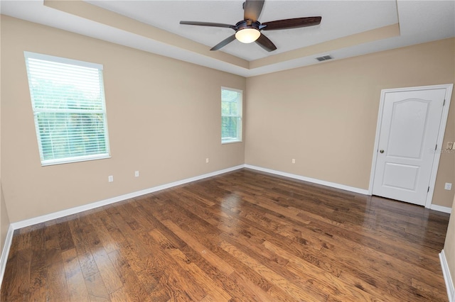 228 Magneta Loop, Auburndale, FL 33823 - empty room featuring a raised ceiling, dark wood-type flooring, and ceiling fan
