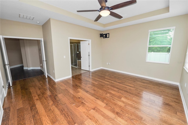228 Magneta Loop, Auburndale, FL 33823 - unfurnished bedroom featuring wood finished floors, a raised ceiling, and ceiling fan