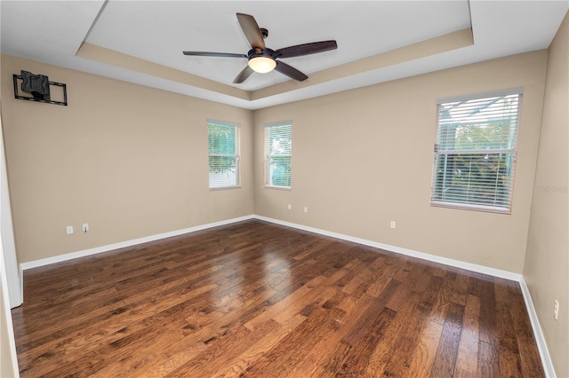 228 Magneta Loop, Auburndale, FL 33823 - unfurnished room featuring a tray ceiling, dark wood-style floors, and a ceiling fan