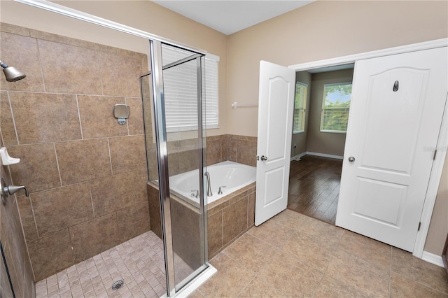 228 Magneta Loop, Auburndale, FL 33823 - bathroom featuring a garden tub, a shower stall, and tile patterned floors