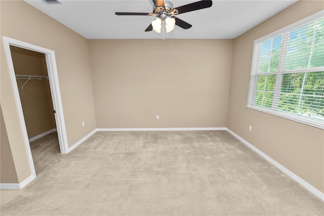 228 Magneta Loop, Auburndale, FL 33823 - unfurnished bedroom with a spacious closet, light carpet, a ceiling fan, and a closet