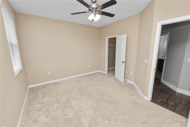 228 Magneta Loop, Auburndale, FL 33823 - unfurnished bedroom featuring carpet floors, a spacious closet, ceiling fan, and a closet
