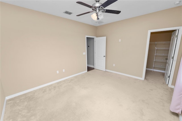 228 Magneta Loop, Auburndale, FL 33823 - unfurnished bedroom featuring light carpet, a spacious closet, a closet, and a ceiling fan