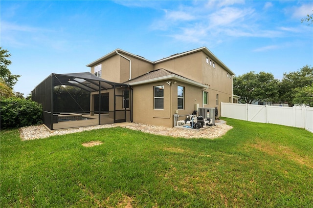 228 Magneta Loop, Auburndale, FL 33823 - back of property with a fenced backyard, a patio, stucco siding, and glass enclosure