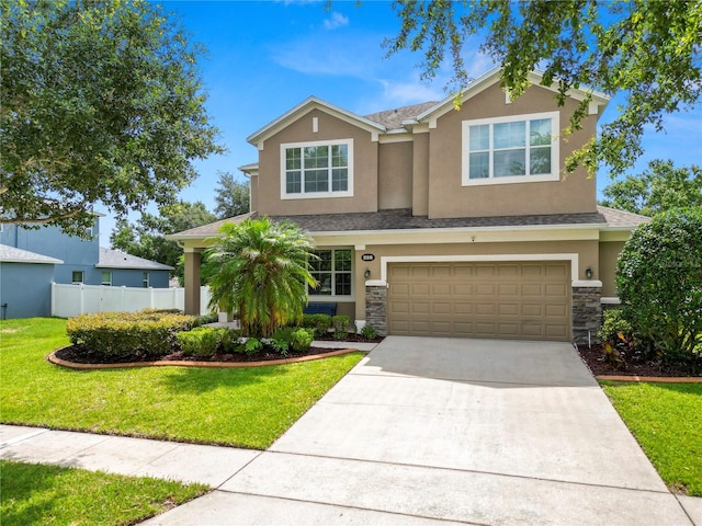 228 Magneta Loop, Auburndale, FL 33823 - view of front of property featuring stucco siding, concrete driveway, an attached garage, and stone siding