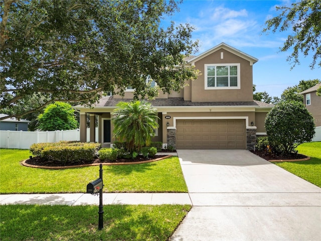 228 Magneta Loop, Auburndale, FL 33823 - view of front of home featuring stucco siding, an attached garage, driveway, and stone siding