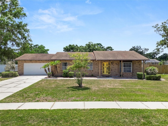 3315 Cross Fox Dr, Mulberry, FL 33860 - ranch-style house featuring a garage, driveway, and brick siding