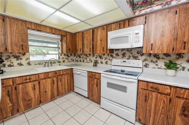 3315 Cross Fox Dr, Mulberry, FL 33860 - kitchen featuring white appliances, brown cabinetry, and light countertops