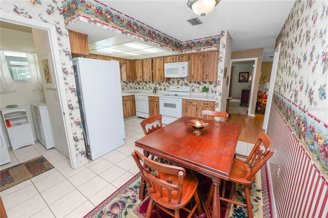 3315 Cross Fox Dr, Mulberry, FL 33860 - dining space featuring wallpapered walls, washer / clothes dryer, and light tile patterned floors