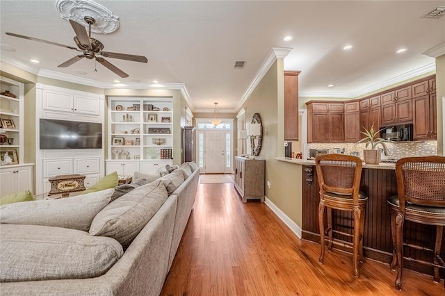 1589 Royal Forest Ct, Lakeland, FL 33811 - living area with ceiling fan, ornamental molding, light wood finished floors, and recessed lighting