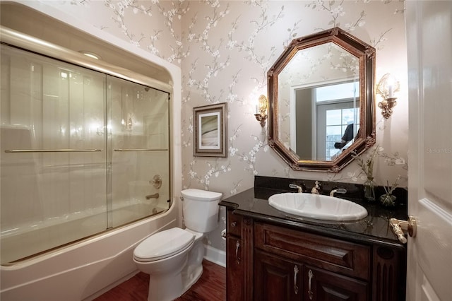 1589 Royal Forest Ct, Lakeland, FL 33811 - full bath featuring wallpapered walls, vanity, shower / bath combination with glass door, and wood finished floors
