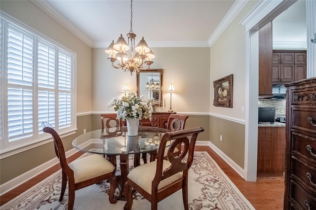 1589 Royal Forest Ct, Lakeland, FL 33811 - dining room with a chandelier, light wood-style floors, and ornamental molding