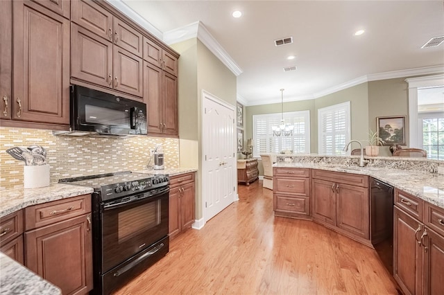 1589 Royal Forest Ct, Lakeland, FL 33811 - kitchen with black appliances, crown molding, light wood-style flooring, a chandelier, and decorative backsplash