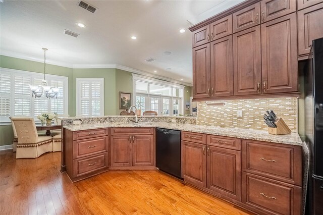 1589 Royal Forest Ct, Lakeland, FL 33811 - kitchen with black appliances, crown molding, a peninsula, light wood-style floors, and a chandelier