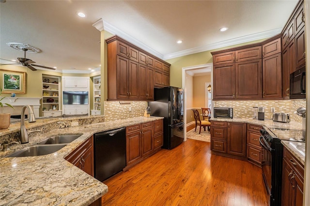 1589 Royal Forest Ct, Lakeland, FL 33811 - kitchen featuring black appliances, ornamental molding, ceiling fan, light stone counters, and wood finished floors