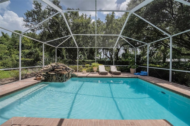 1589 Royal Forest Ct, Lakeland, FL 33811 - swimming pool with a lanai and view of scattered trees