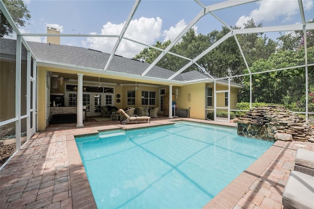 1589 Royal Forest Ct, Lakeland, FL 33811 - swimming pool with a patio area, outdoor lounge area, glass enclosure, ceiling fan, and french doors