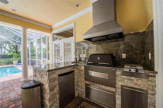 1589 Royal Forest Ct, Lakeland, FL 33811 - kitchen with wall chimney exhaust hood, crown molding, refrigerator, brick floors, and a peninsula