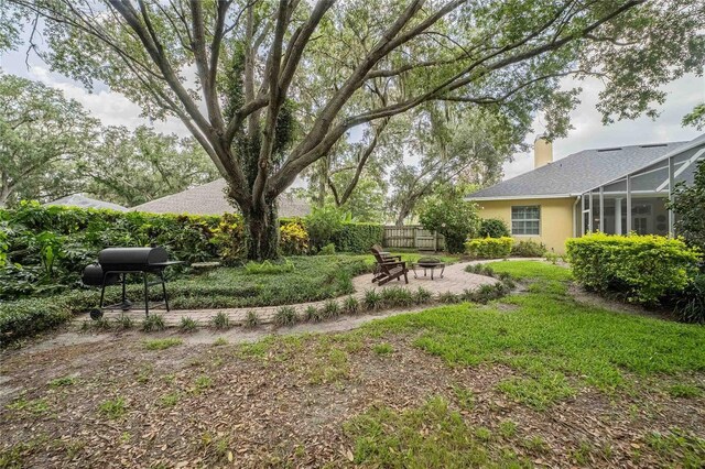 1589 Royal Forest Ct, Lakeland, FL 33811 - view of yard featuring an outdoor fire pit, a lanai, and a patio