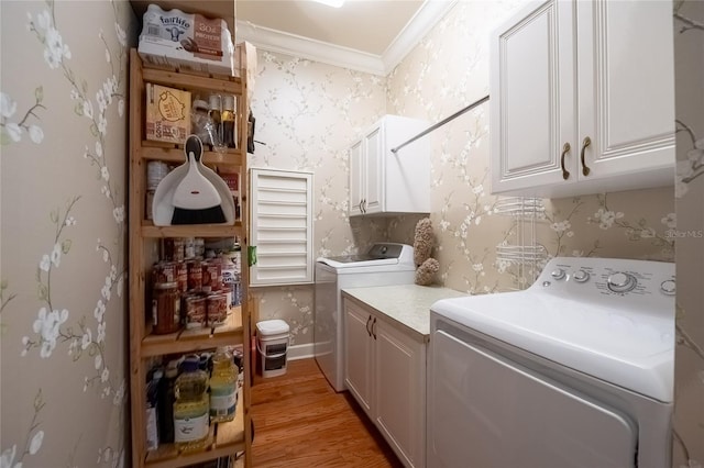 1589 Royal Forest Ct, Lakeland, FL 33811 - laundry area with cabinet space, crown molding, washing machine and dryer, light wood-style floors, and wallpapered walls
