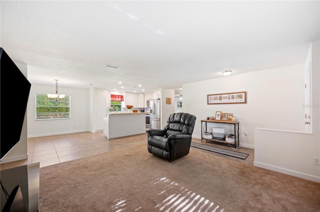 6507 Shadowbrook Run, Lakeland, FL 33813 - living room featuring a chandelier, light tile patterned floors, recessed lighting, and light carpet