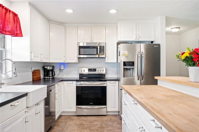 6507 Shadowbrook Run, Lakeland, FL 33813 - kitchen featuring appliances with stainless steel finishes, white cabinets, recessed lighting, and light tile patterned flooring