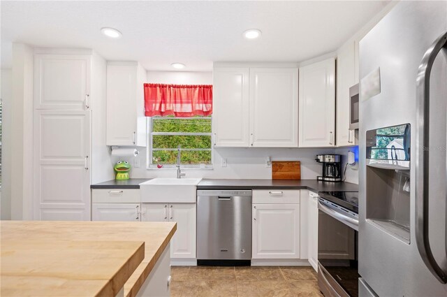 6507 Shadowbrook Run, Lakeland, FL 33813 - kitchen featuring stainless steel appliances, white cabinets, recessed lighting, and light tile patterned floors