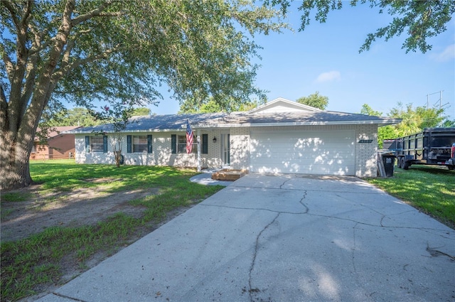 6507 Shadowbrook Run, Lakeland, FL 33813 - single story home with an attached garage, driveway, brick siding, and a front lawn