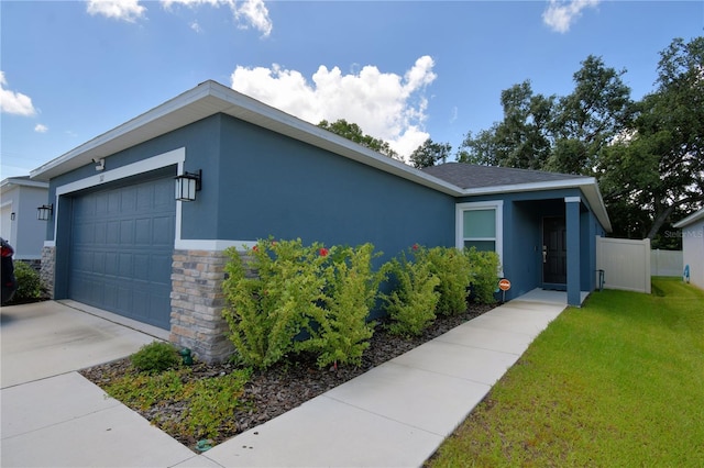 312 Walnut Ln, Auburndale, FL 33823 - view of front of house with stucco siding, a garage, and stone siding