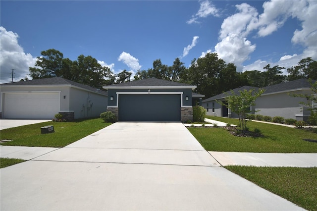 312 Walnut Ln, Auburndale, FL 33823 - view of front of home featuring a front lawn, stone siding, driveway, and stucco siding