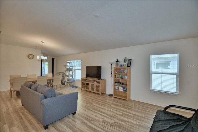 312 Walnut Ln, Auburndale, FL 33823 - living area featuring a chandelier and light wood-type flooring