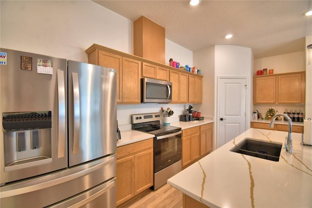 312 Walnut Ln, Auburndale, FL 33823 - kitchen with stainless steel appliances, light stone countertops, recessed lighting, and light wood-type flooring