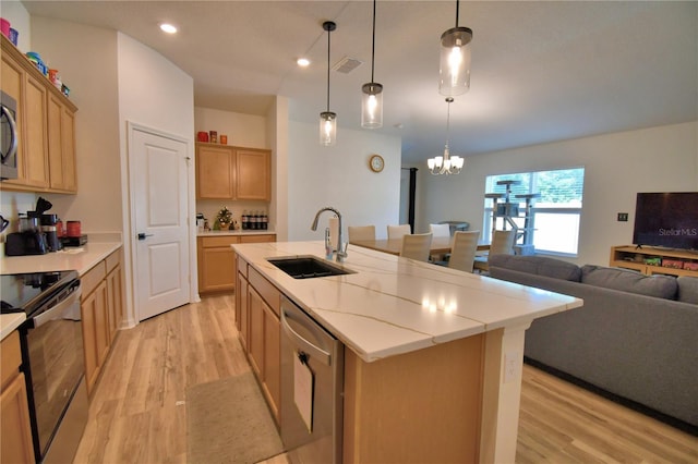 312 Walnut Ln, Auburndale, FL 33823 - kitchen with stainless steel dishwasher, range with electric stovetop, light wood-style flooring, recessed lighting, and an island with sink